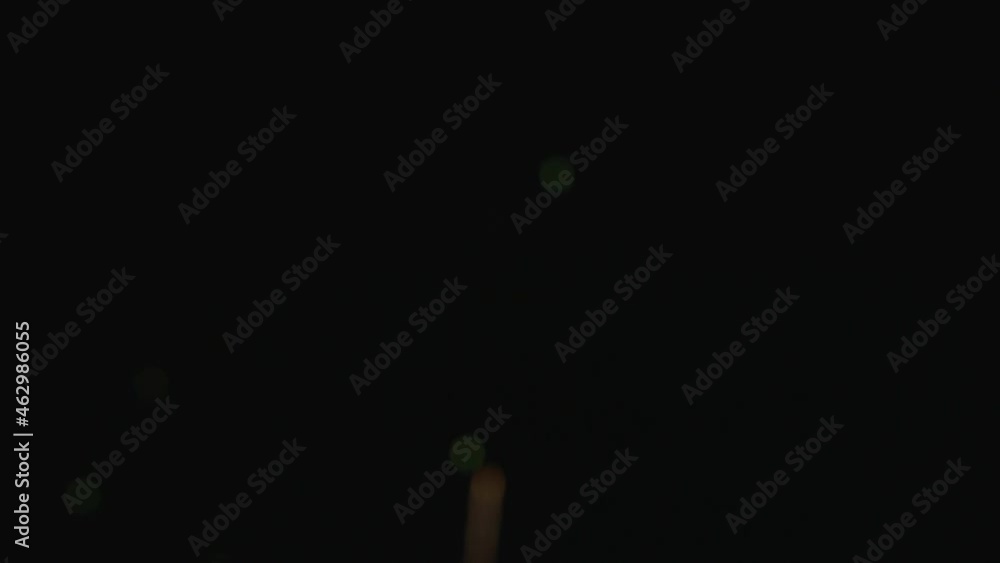 Poster glowing bokeh fireworks display on dark sky. low angle