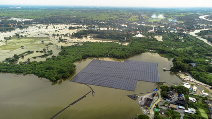 Solar panels on water in aerial view, rows array of polycrystalline silicon solar cells or photovoltaics in Floating Solar Farm on the water in lake.