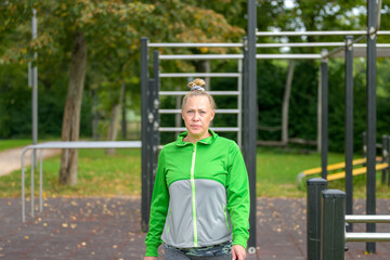 Athletic middle-aged woman looking pensively at the camera