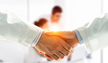 Partnership concept. Image of handshake . Mixed media
