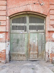 Old wooden door in stone house