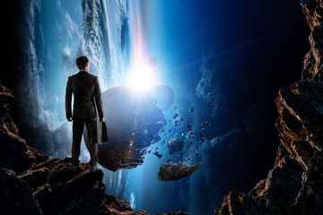 Image of businessman facing outer space.