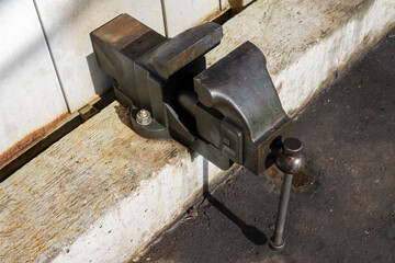 Oblique angle shot of a vise outdoors, taken from an angle.