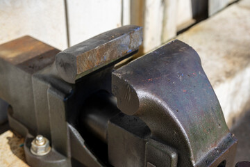 Oblique angle shot of a vise outdoors, taken from an angle.