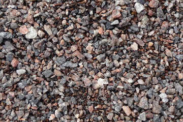 Close up of small grey and brown pebbles stone pattern. Full frame. Background or backdrop.
