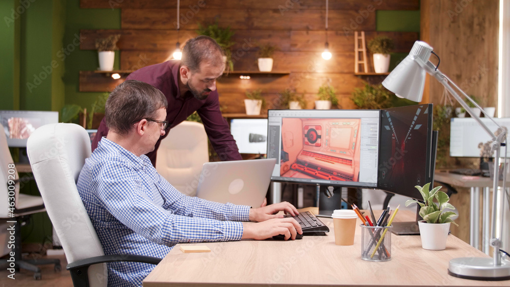 Aufkleber graphic designer in game industry sitting at his office discussing video game graphic environment wo