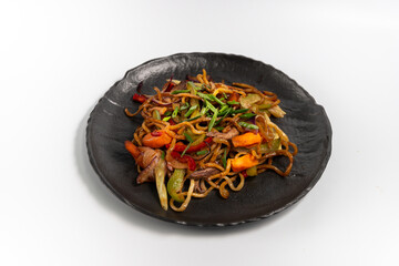 Lagman fried on a black plate on a white background