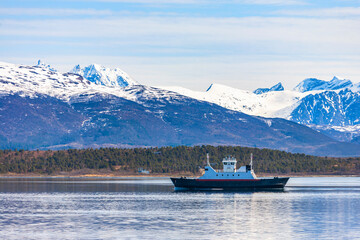 Ferry in a Norwegian fjord in a mountainous landscape