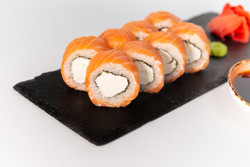 philadelphia sushi on a blackboard on a white background close up