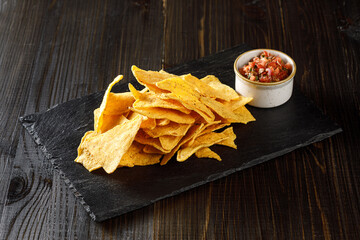chips and salsa on black stone plate