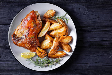 roasted pork shanks with potatoes on a plate