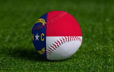 Baseball with North Carolina flag on green grass background, close up