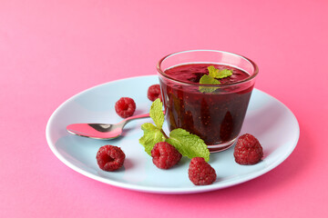 Concept of tasty food with raspberry jam on pink background