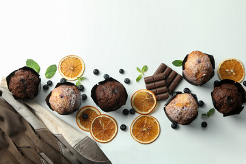 Concept of delicious food with chocolate muffins on white background