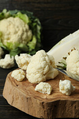 Concept of tasty food with cauliflower on wooden background