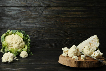 Concept of tasty food with cauliflower on wooden background