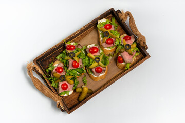 Bruschetta with roast beef and vitello tonnato sauce
on a white background top view