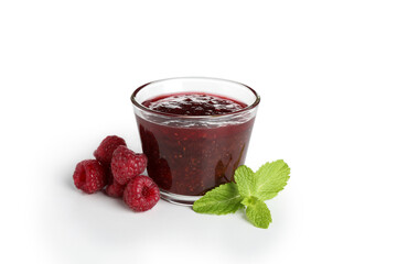 Glass bowl of raspberry jam isolated on white background