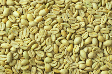 Food background of Green coffee beans, top view