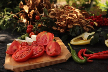 peppers on a chopping board Food photography, plating of cherry tomatoes, mushrooms, peppers and...