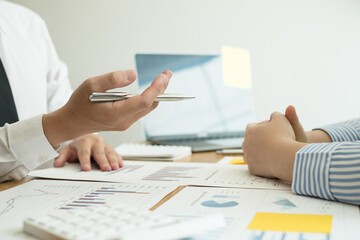 Two business leaders talk about charts, financial graphs showing results are analyzing and calculating planning strategies, business success building processes