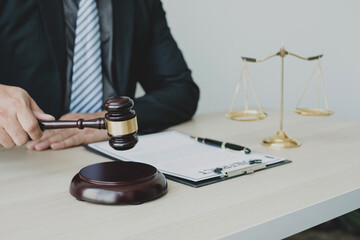 Professional man lawyers work at a law office There are scales, Scales of justice, judges gavel, and litigation documents. Concepts of law and justice