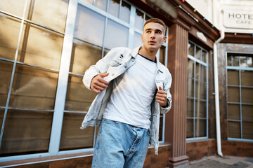 Portrait of handsome young casual man walking on the street
