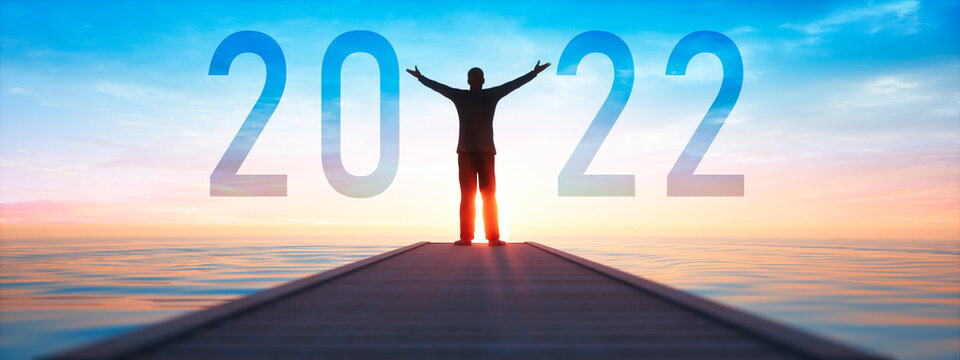 Silhouette of a man and number 2021 concept at beautiful sunset sky and sea background