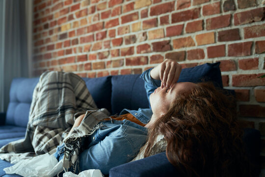 Young Caucasian Woman Lying On Sofa And Having A Serious Sinus Infection