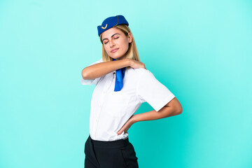 Airplane stewardess Uruguayan woman isolated on blue background suffering from pain in shoulder for having made an effort