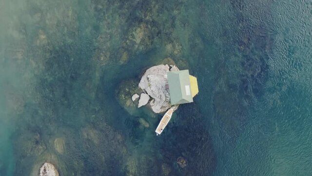 Small wooden cabin on a rock in the middle of river Drina, Serbia.