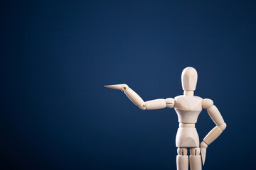 wooden man with hand up on blue background to hold up your banner