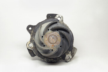old rusty car water pump, showing plastic impeller with curved blades. with clipping path