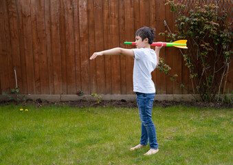 Active kid preparing to throwing a Javelin, Healhty Child practicing athletics throw Javelin. Young...