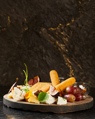 assortment of cheese and fruits with honey and red sauce