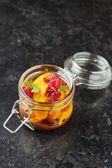 glass jar of sorbet with frozen fruits 