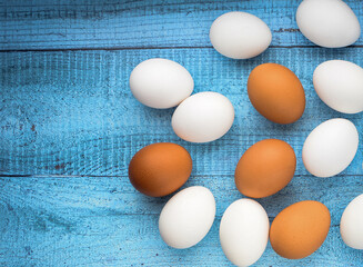 Chicken eggs. Ingredient for breakfast on a colored wooden background. Top view, flat lay.