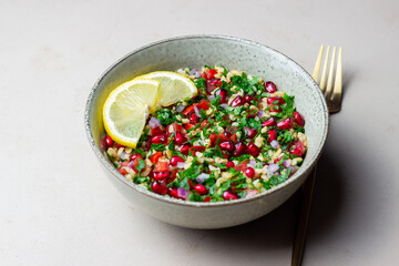 Tabbouleh salad with bulgur, mint, parsley, tomatoes and pomegranate. Healthy eating. Vegetarian food.