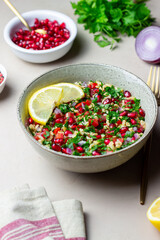 Tabbouleh salad with bulgur, mint, parsley, tomatoes and pomegranate. Healthy eating. Vegetarian food.