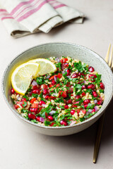 Tabbouleh salad with bulgur, mint, parsley, tomatoes and pomegranate. Healthy eating. Vegetarian food.