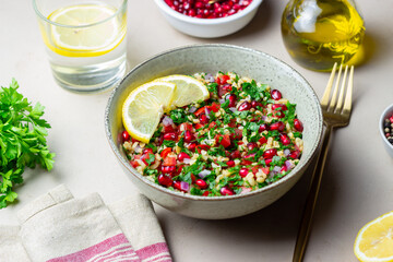 Tabbouleh salad with bulgur, mint, parsley, tomatoes and pomegranate. Healthy eating. Vegetarian food.