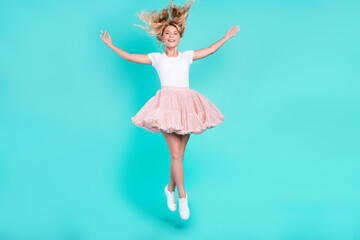 Photo of lovely cute candid lady jump throw hair wear white t-shirt skirt shoes isolated aquamarine color background