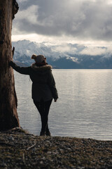 Woman next to a tree in Lake Hawea, Otago, New Zealand.