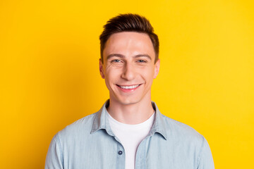 Portrait of attractive content cheerful guy wearing blue shirt isolated over bright yellow color background
