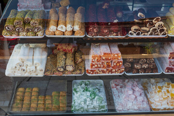 The streets of the city centre, the bazaar and the port area in Side, Antalya. The window of a shop selling Turkish delight. with some reflection.