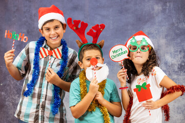 Three funny kids celebrating Christmas