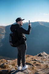 Tourist takes on smartphone mountain scenery