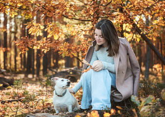 Beautiful Young Girl With Her Dog In The Forest