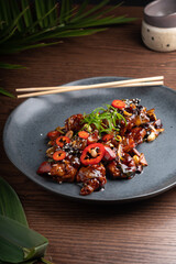 delicious asian dish, asian spicy food served in black plate