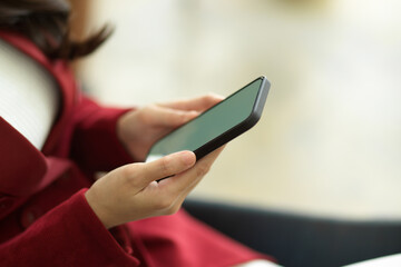 Side view of businesswoman using smart mobile phone to chatting with her friends